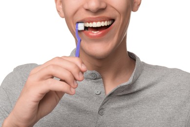 Photo of Young man brushing his teeth on white background, closeup