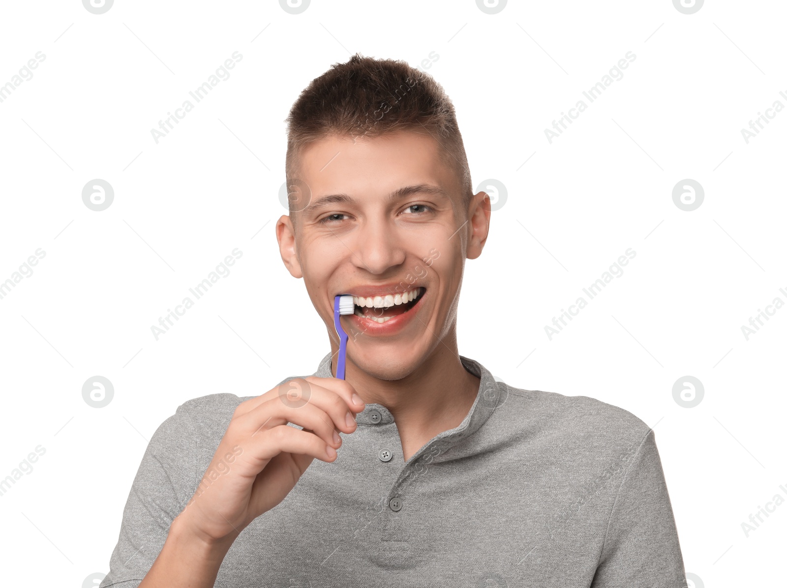 Photo of Young man brushing his teeth on white background