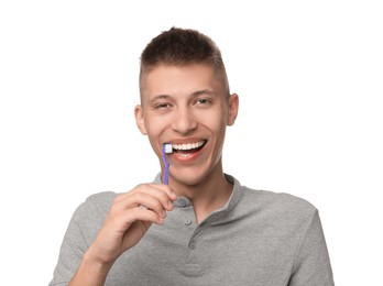 Photo of Young man brushing his teeth on white background