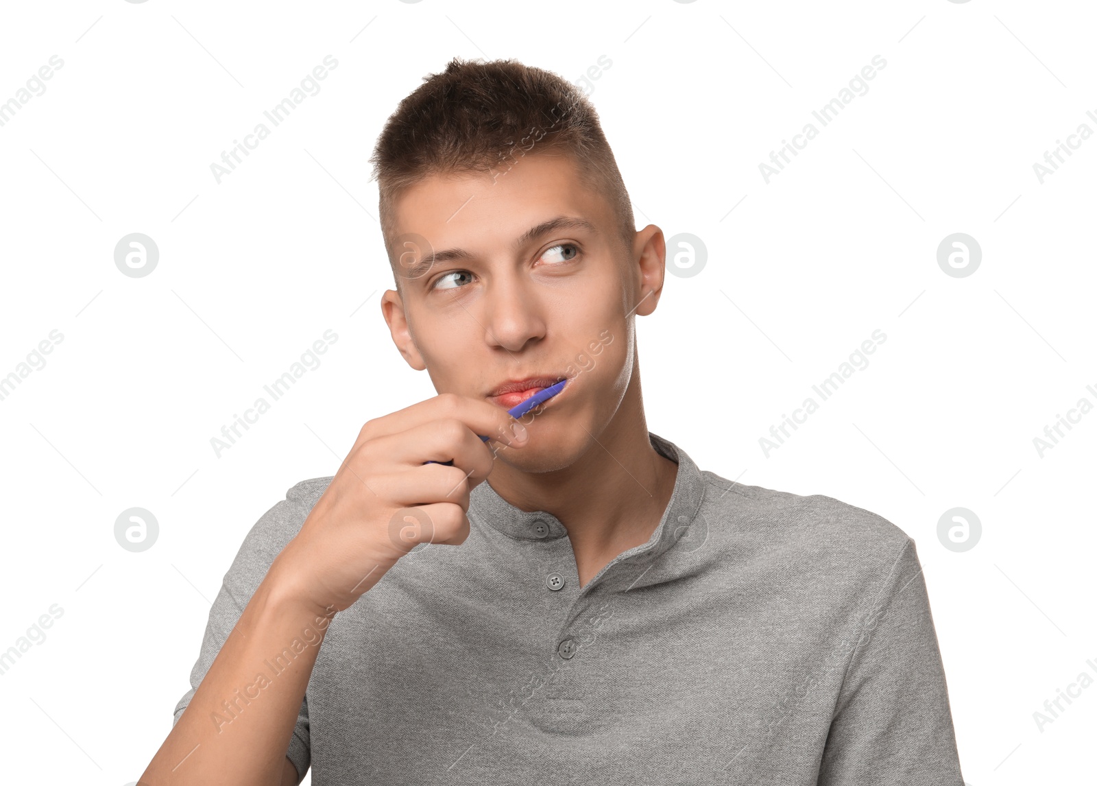 Photo of Young man brushing his teeth on white background