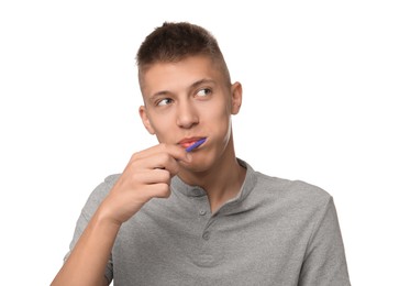 Photo of Young man brushing his teeth on white background