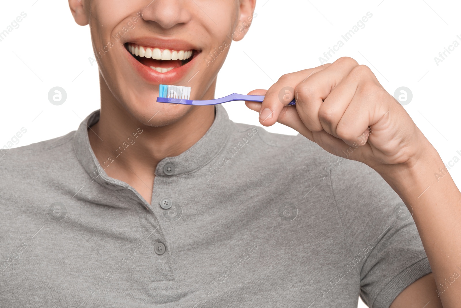 Photo of Young man brushing his teeth on white background, closeup