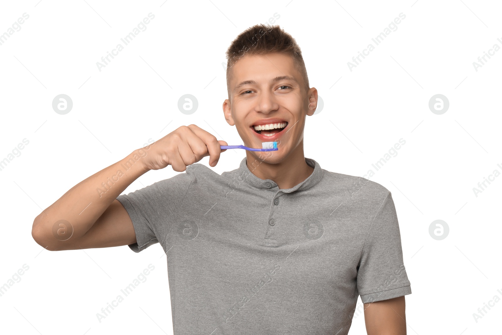 Photo of Young man brushing his teeth on white background