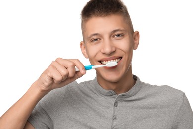 Photo of Young man brushing his teeth on white background