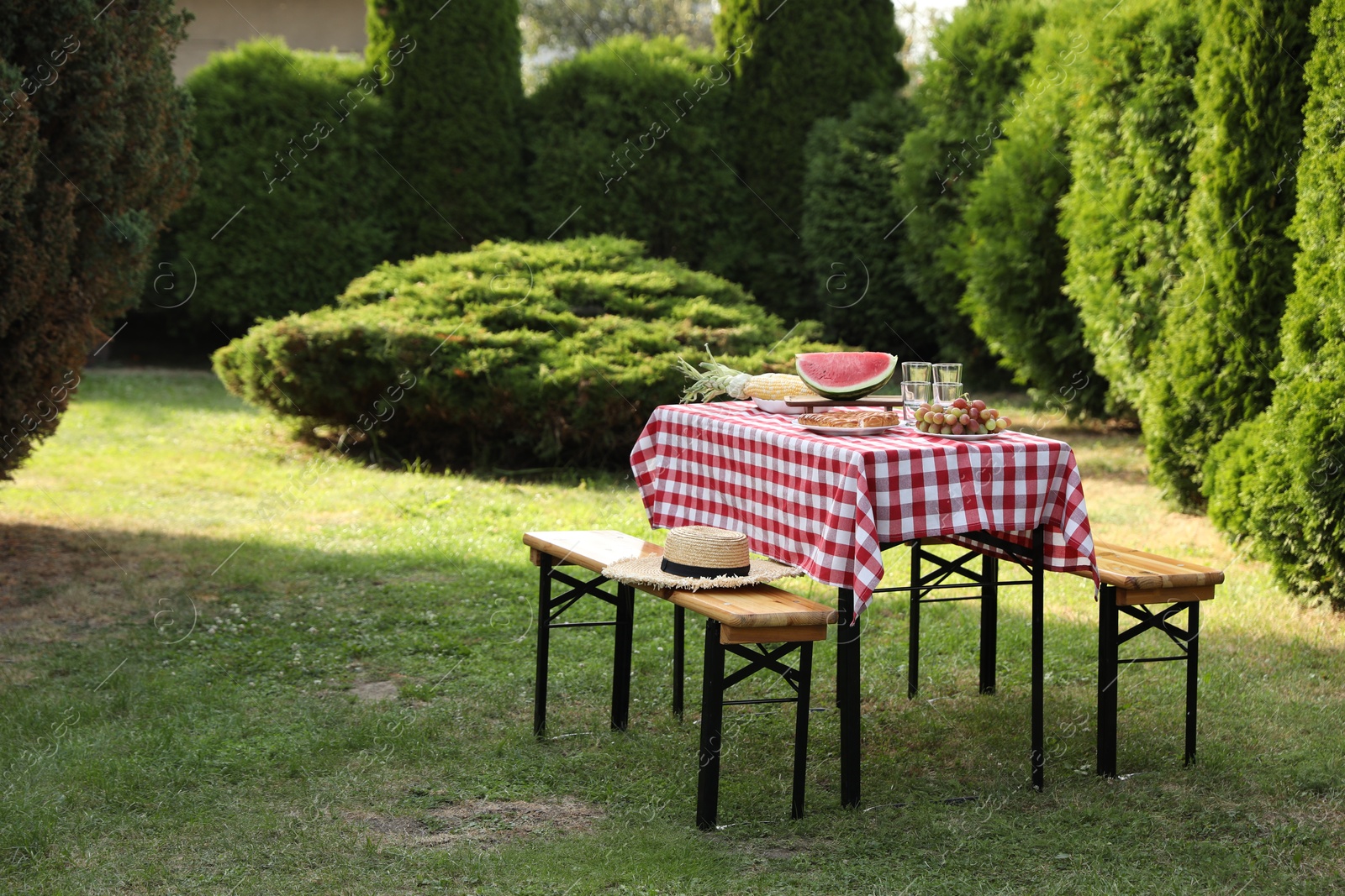 Photo of Fresh fruits and pie on table in garden, space for text