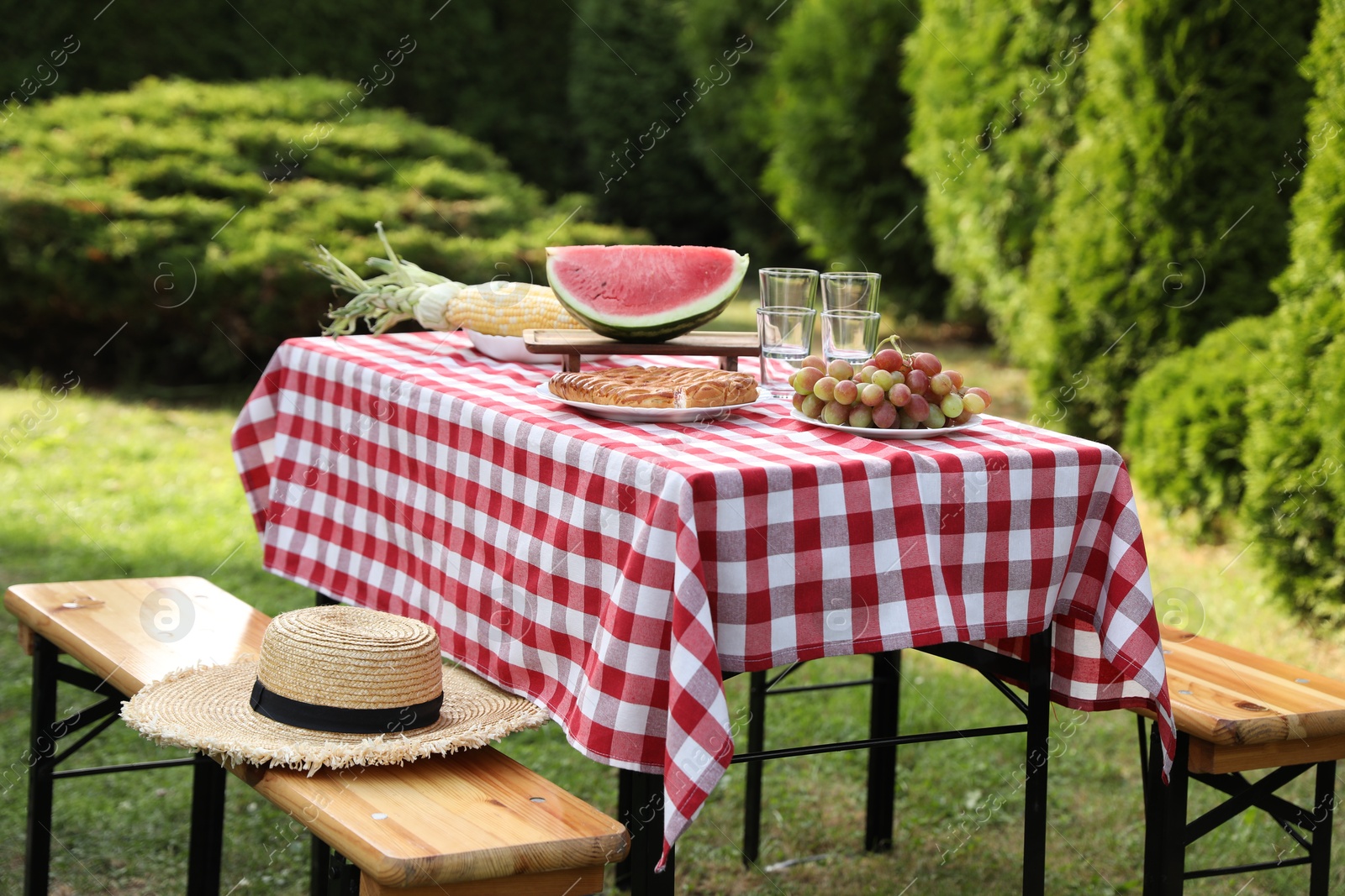 Photo of Fresh fruits and pie on table in garden