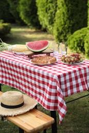 Photo of Fresh fruits and pie on table in garden