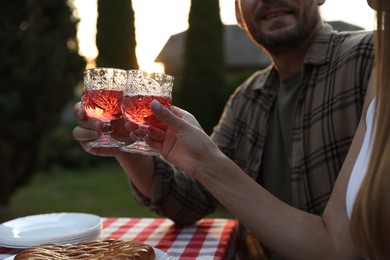 Couple having romantic date at table in garden, closeup