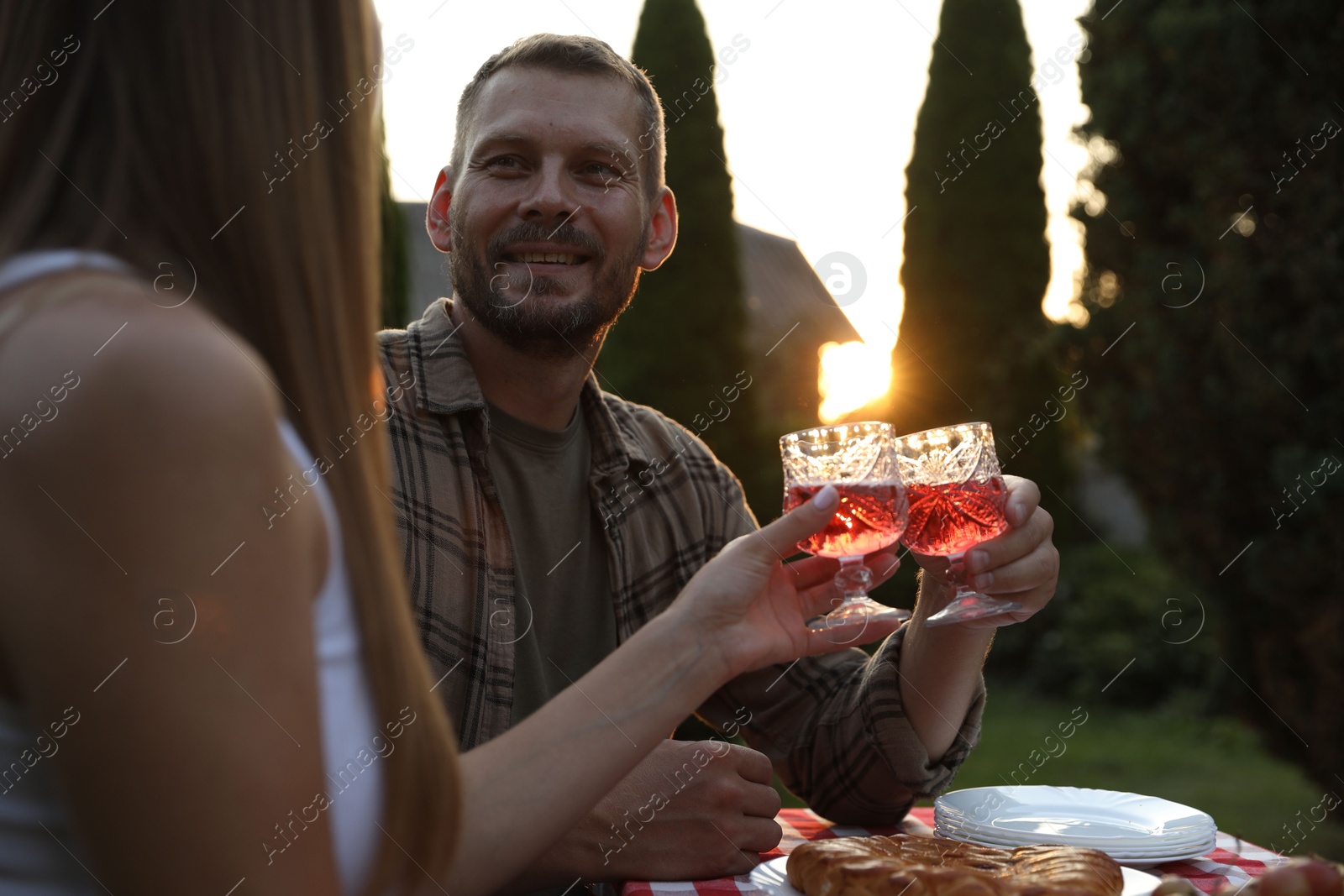 Photo of Couple having romantic date at table in garden