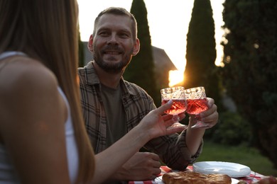 Photo of Couple having romantic date at table in garden