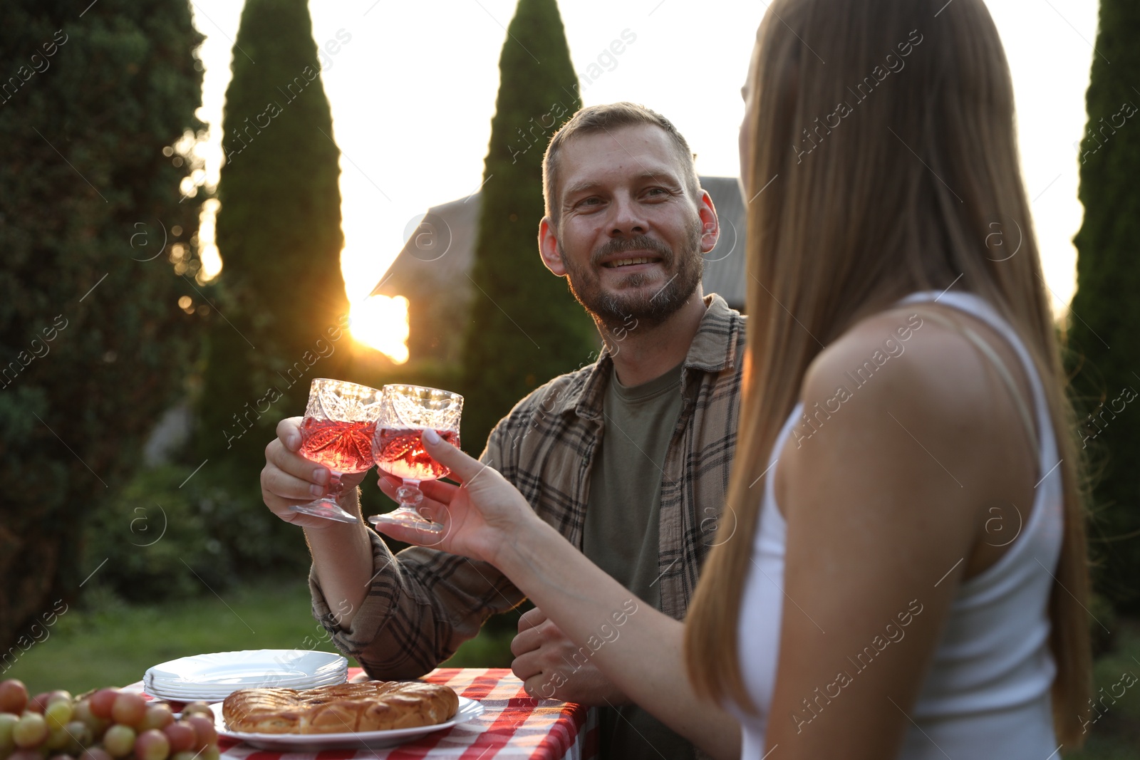 Photo of Couple having romantic date at table in garden