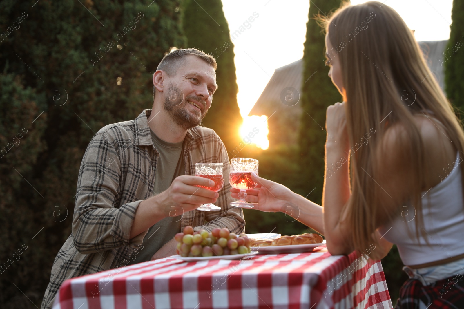 Photo of Couple having romantic date at table in garden