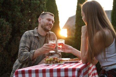 Photo of Couple having romantic date at table in garden