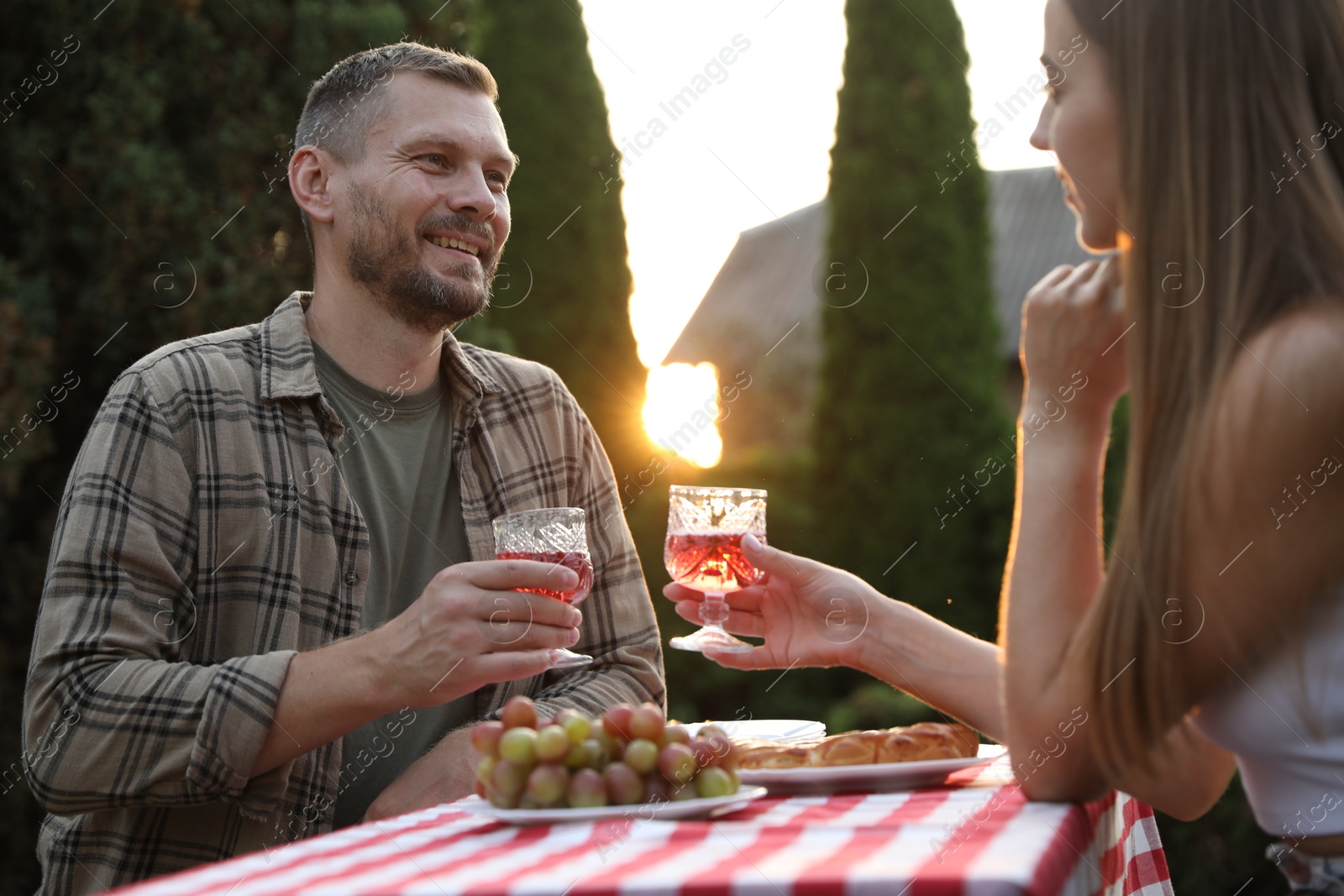 Photo of Couple having romantic date at table in garden