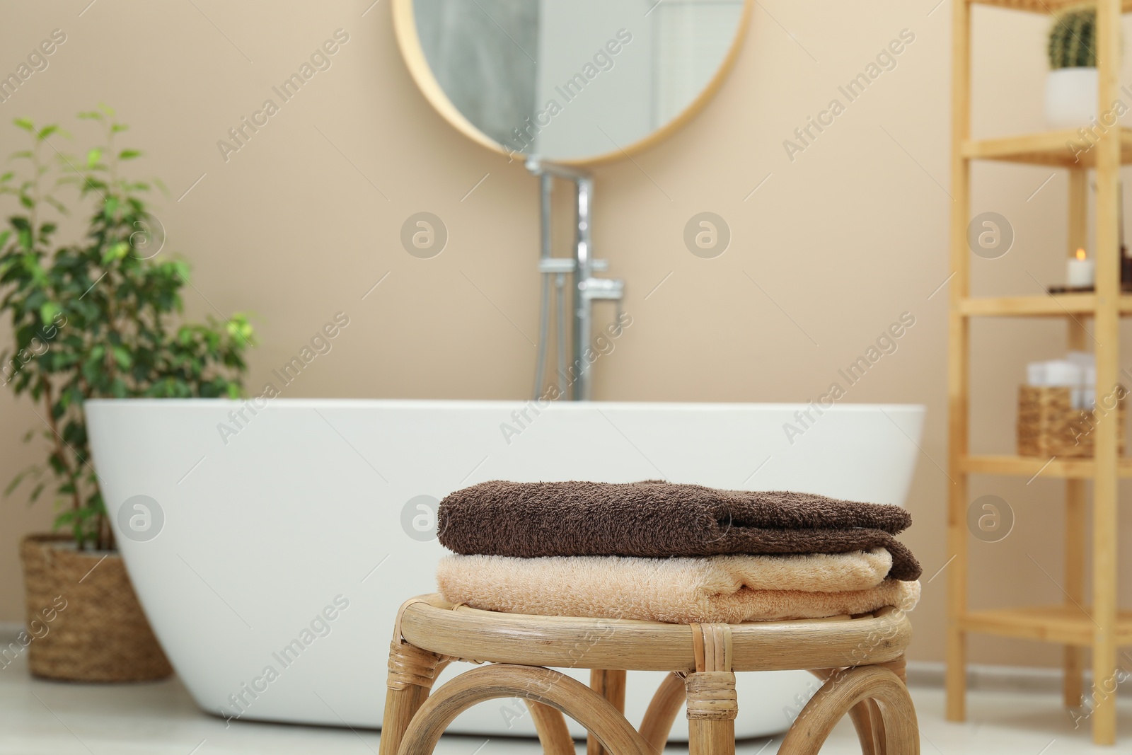 Photo of Stack of clean towels on table in bathroom