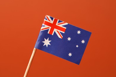 Photo of Small paper flag of Australia on orange background