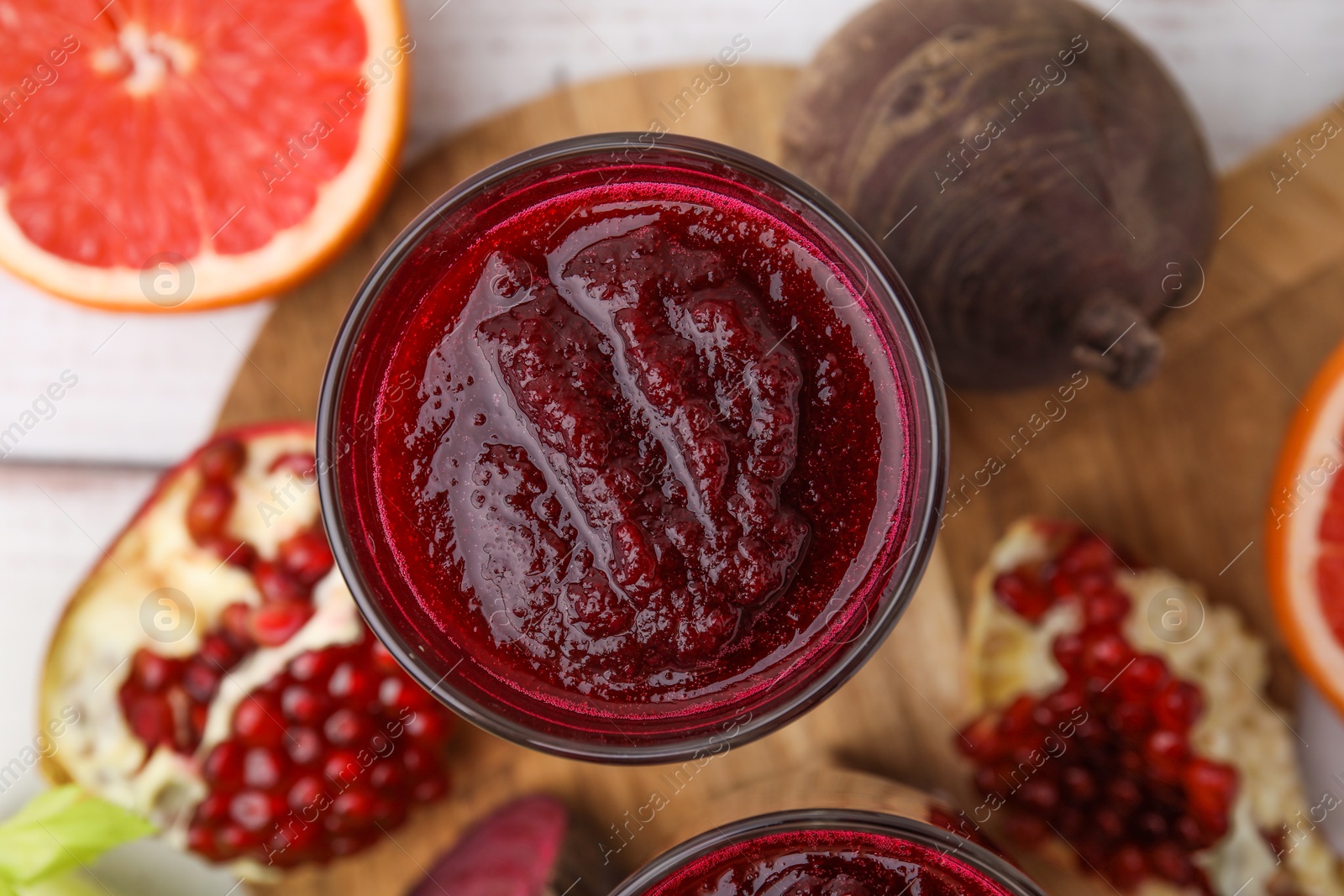 Photo of Fresh beetroot smoothie on white table, flat lay