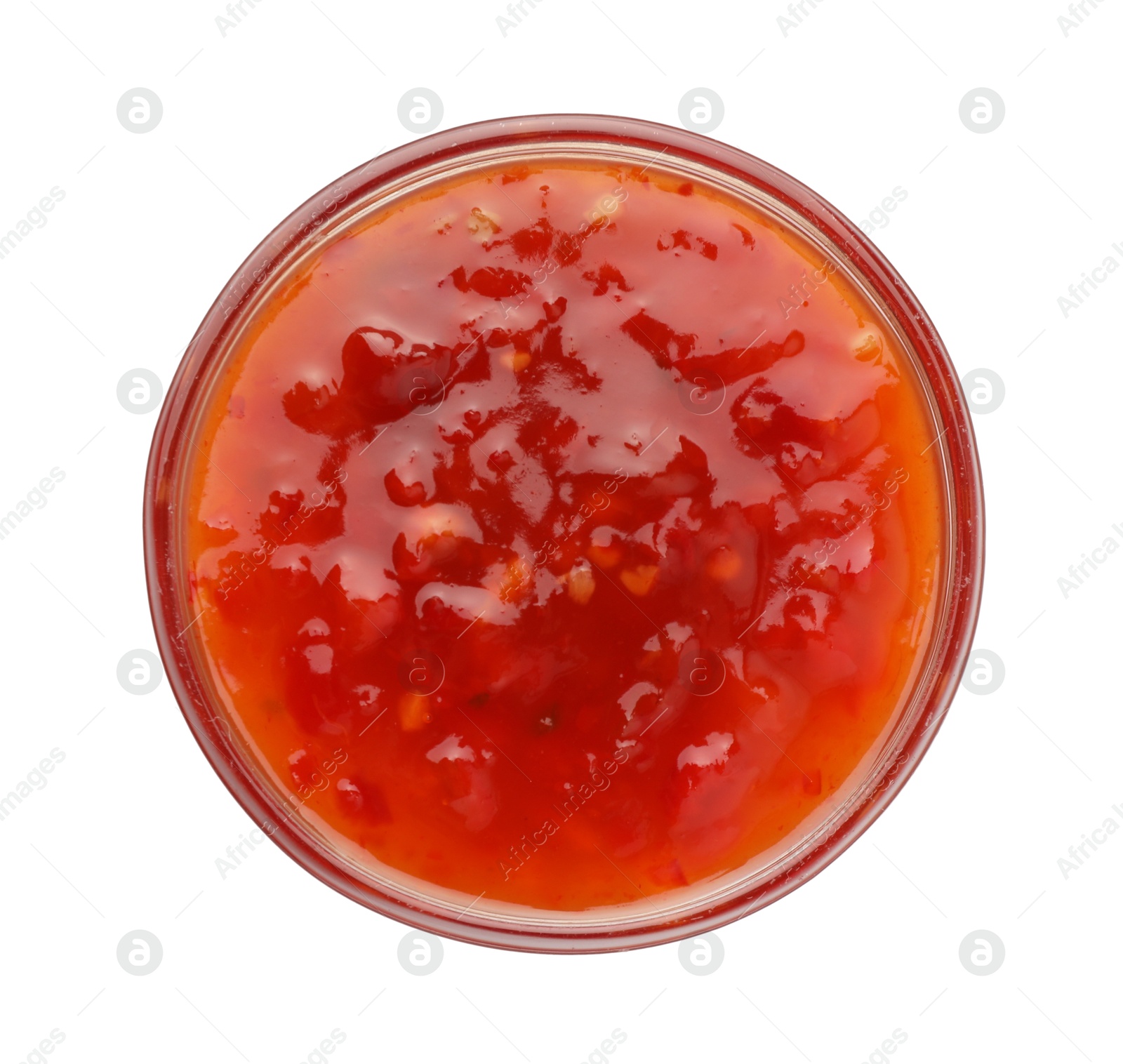 Photo of Hot chili sauce in bowl isolated on white, top view