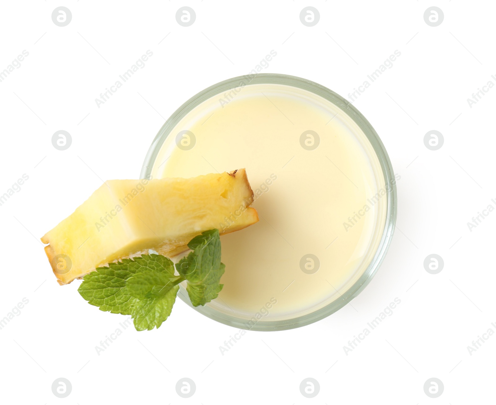 Photo of Tasty pineapple smoothie with slice of fresh fruit and mint in glass isolated on white, top view