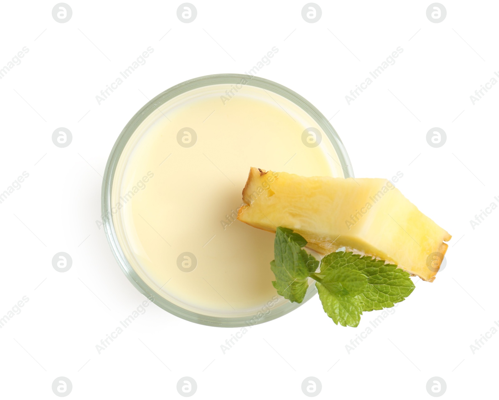 Photo of Tasty pineapple smoothie with slice of fresh fruit and mint in glass isolated on white, top view