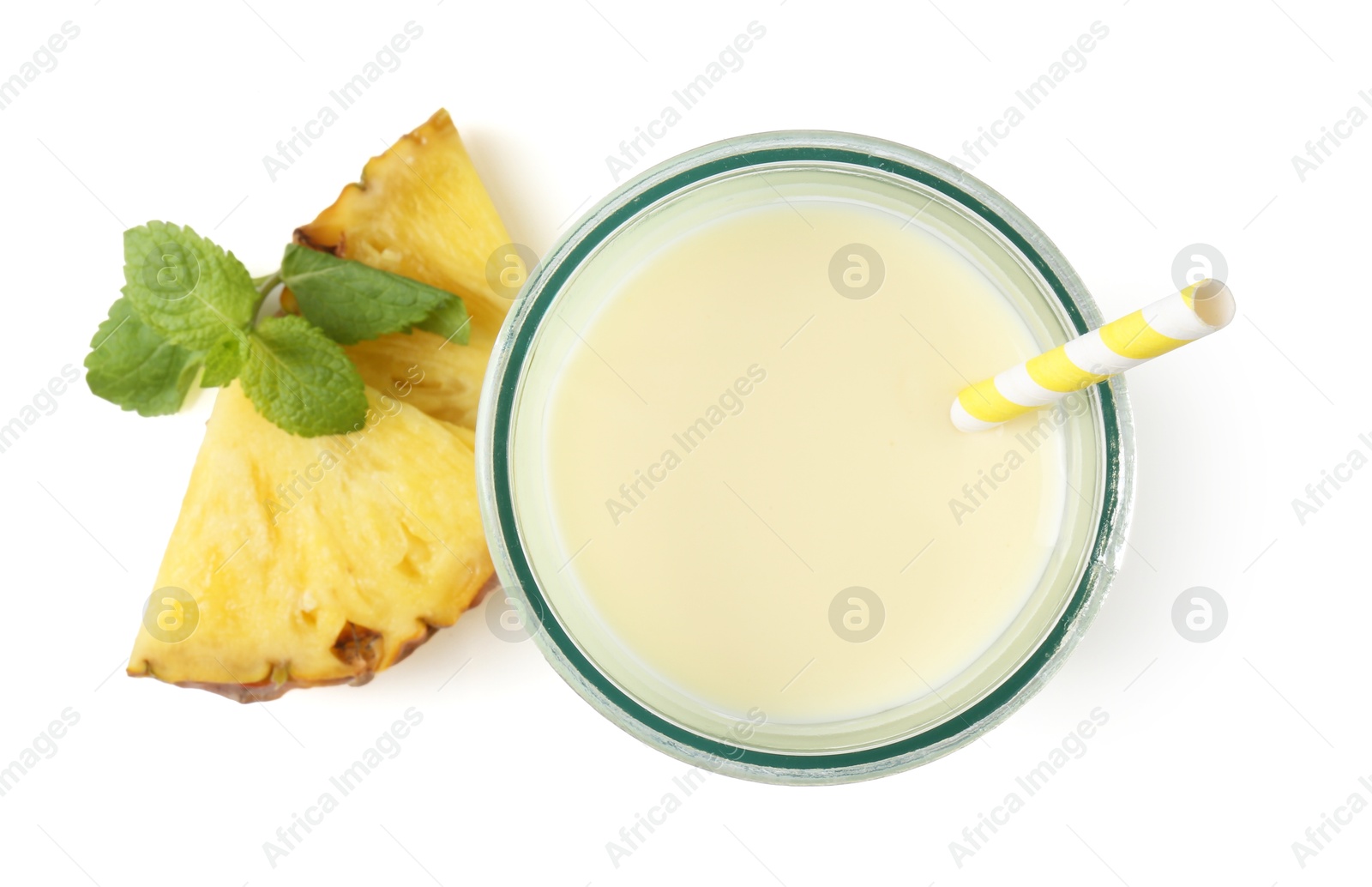 Photo of Tasty pineapple smoothie in glass, slices of fresh fruit and mint isolated on white, top view