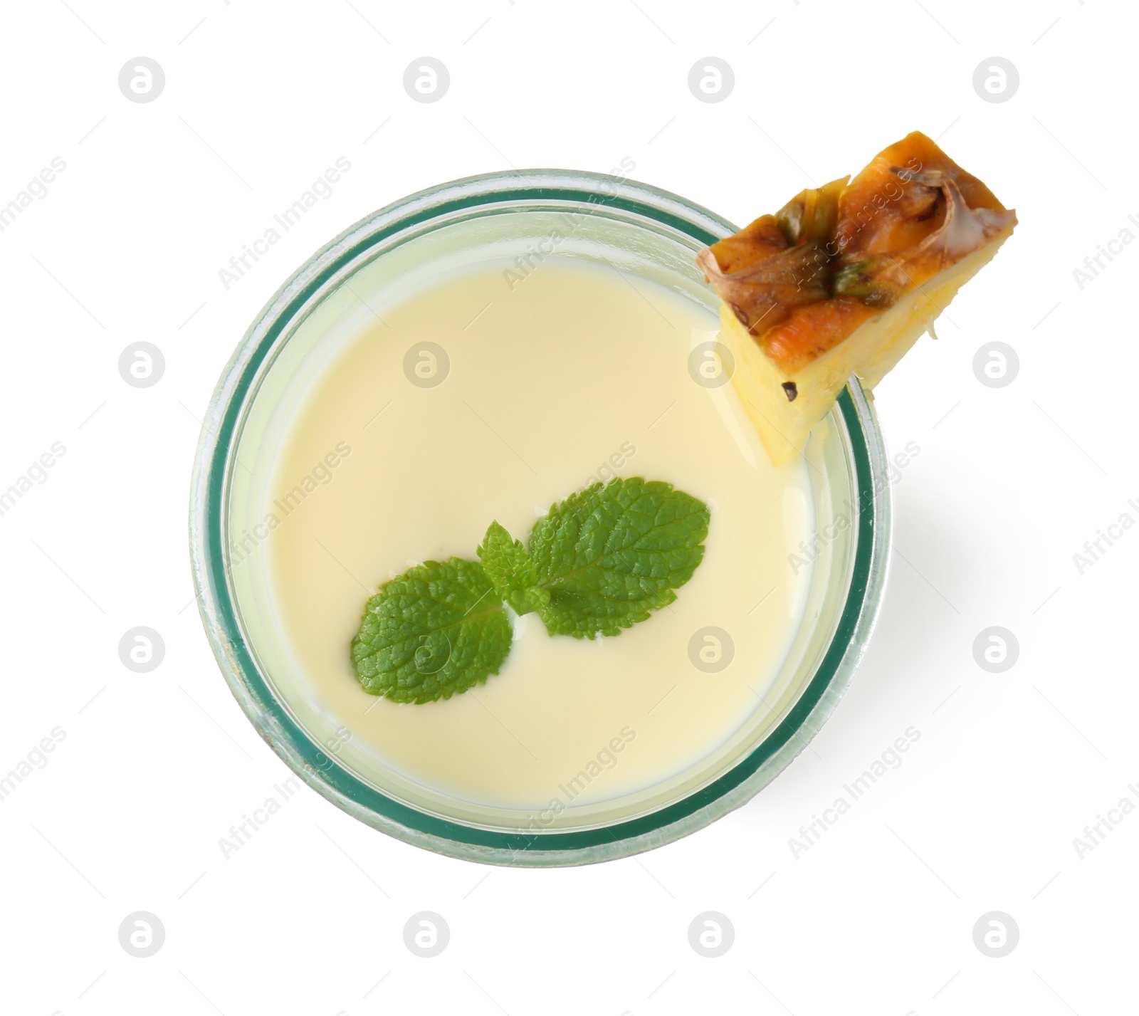 Photo of Tasty pineapple smoothie with slice of fresh fruit and mint in glass isolated on white, top view