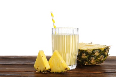 Photo of Tasty pineapple smoothie in glass and slices of fruit on wooden table against white background. Space for text