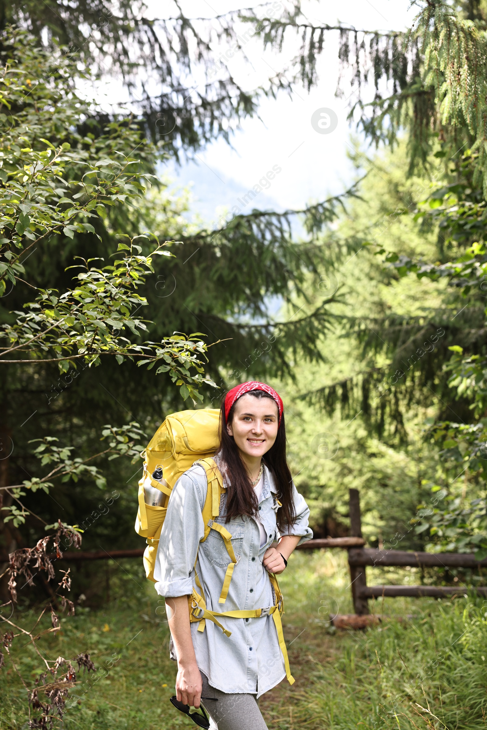 Photo of Young hiker with backpack enjoying time in forest