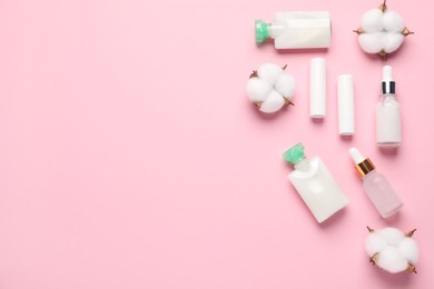 Photo of Different cosmetic products and cotton flowers on pink background, flat lay. Space for text