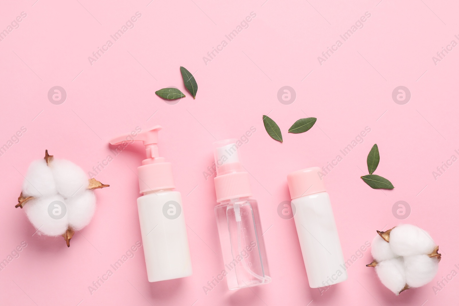 Photo of Different cosmetic products, leaves and cotton flowers on pink background, flat lay. Space for text