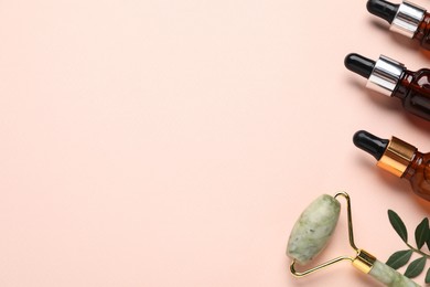 Photo of Different cosmetic products and green leaves on beige background, flat lay. Space for text