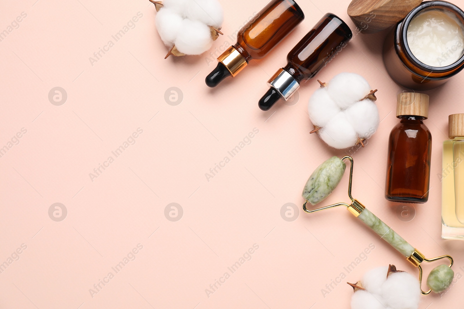 Photo of Different cosmetic products and cotton flowers on beige background, flat lay. Space for text