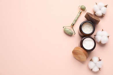 Photo of Different cosmetic products and cotton flowers on beige background, flat lay. Space for text