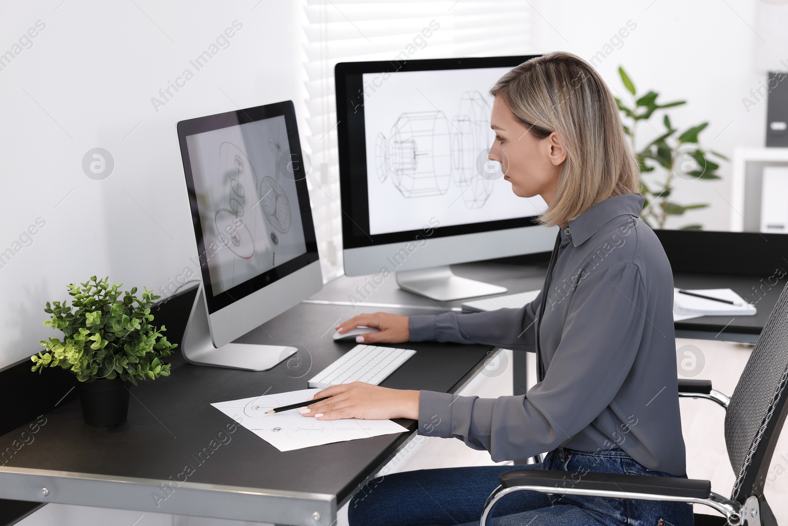 Photo of Architect making engineering drawing at table in office