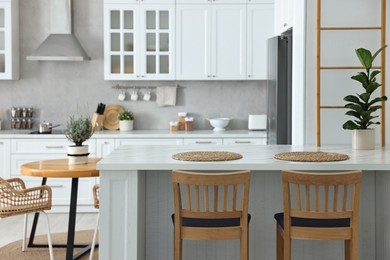 Photo of Stylish kitchen with bar stools. Interior design