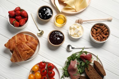 Photo of Different tasty food served for brunch on white wooden table, flat lay