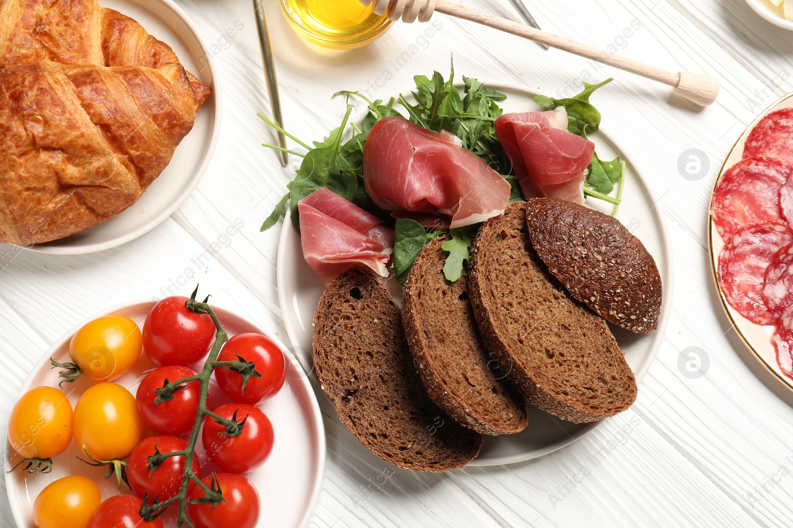 Photo of Different tasty food served for brunch on white wooden table, flat lay