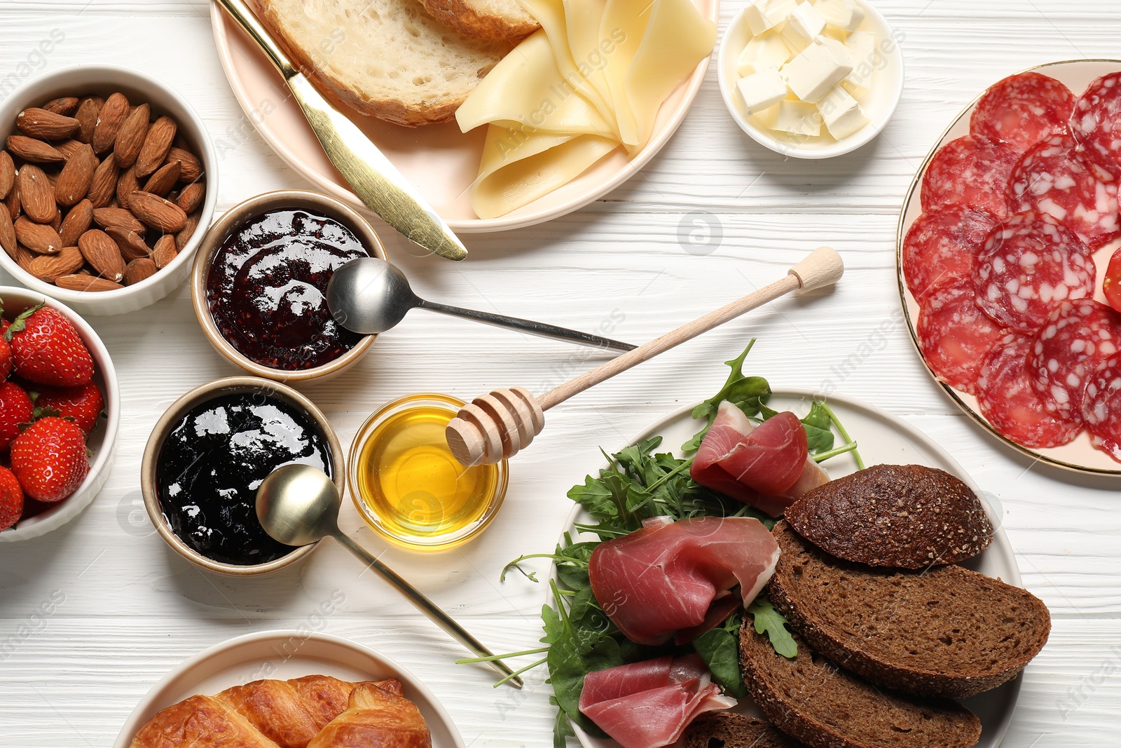 Photo of Different tasty food served for brunch on white wooden table, flat lay