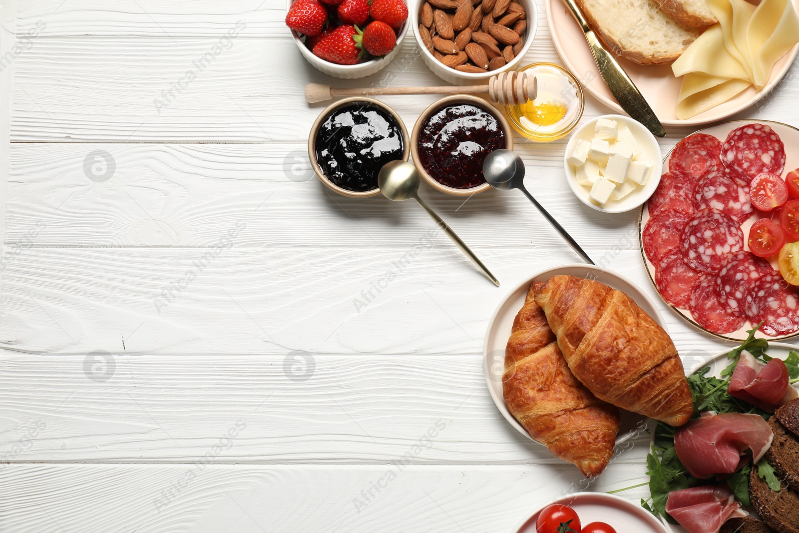 Photo of Different tasty food served for brunch on white wooden table, flat lay. Space for text