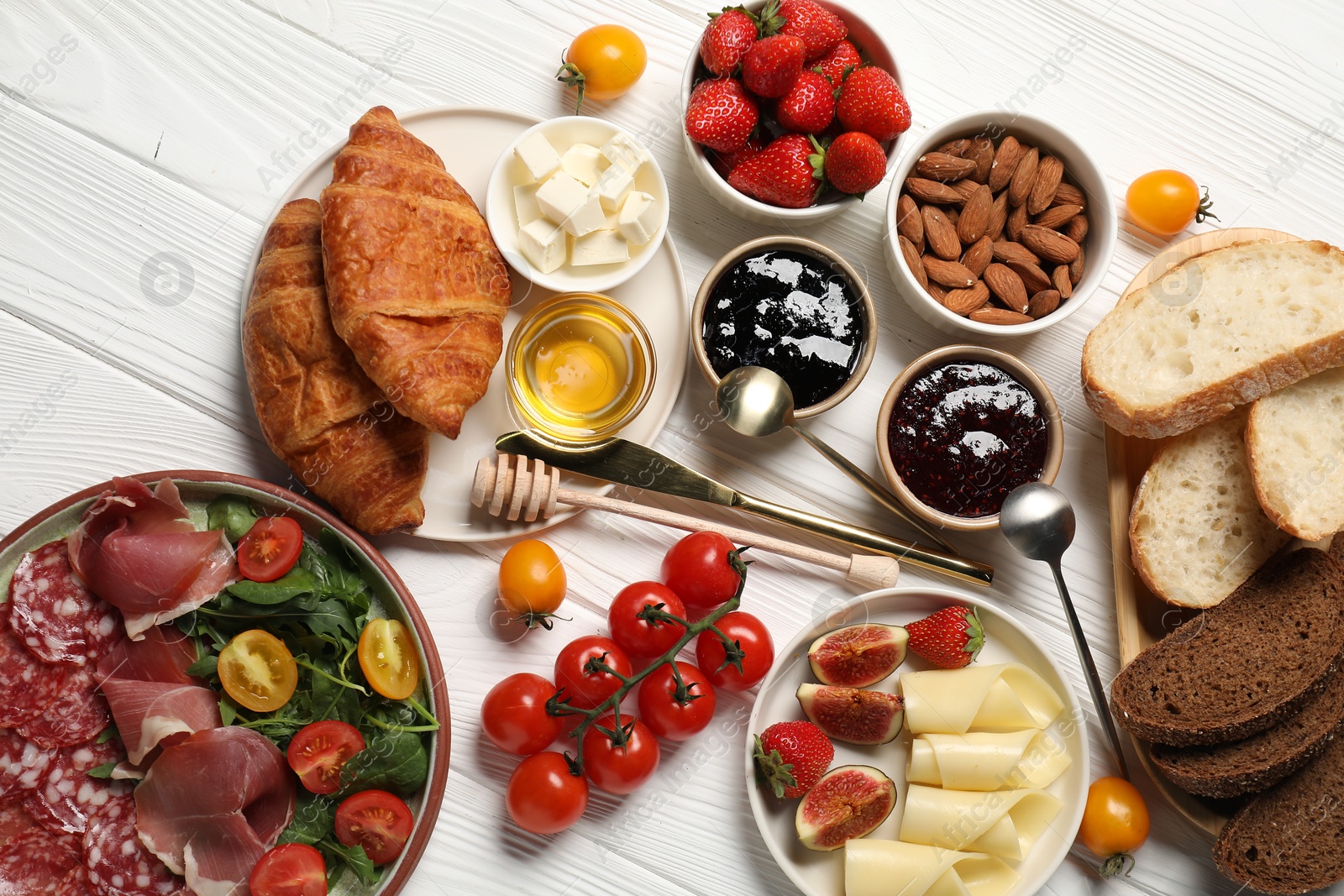 Photo of Different tasty food served for brunch on white wooden table, flat lay