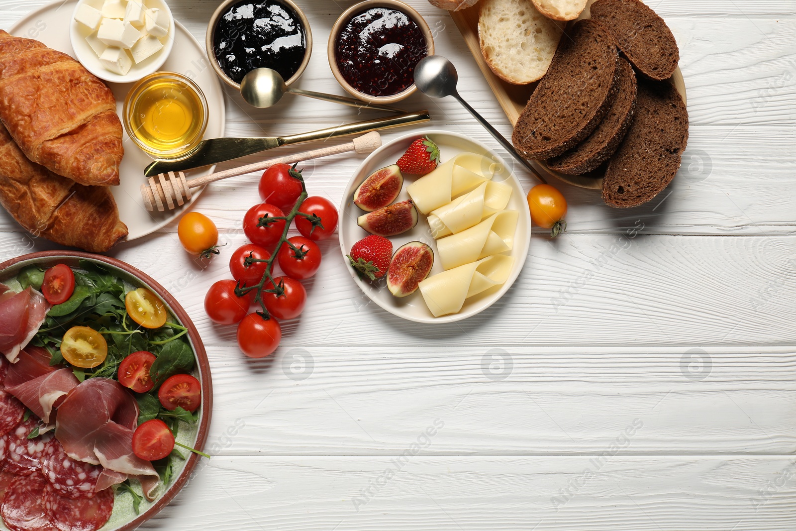 Photo of Different tasty food served for brunch on white wooden table, flat lay. Space for text