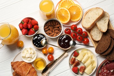 Photo of Different tasty food served for brunch on white wooden table, flat lay