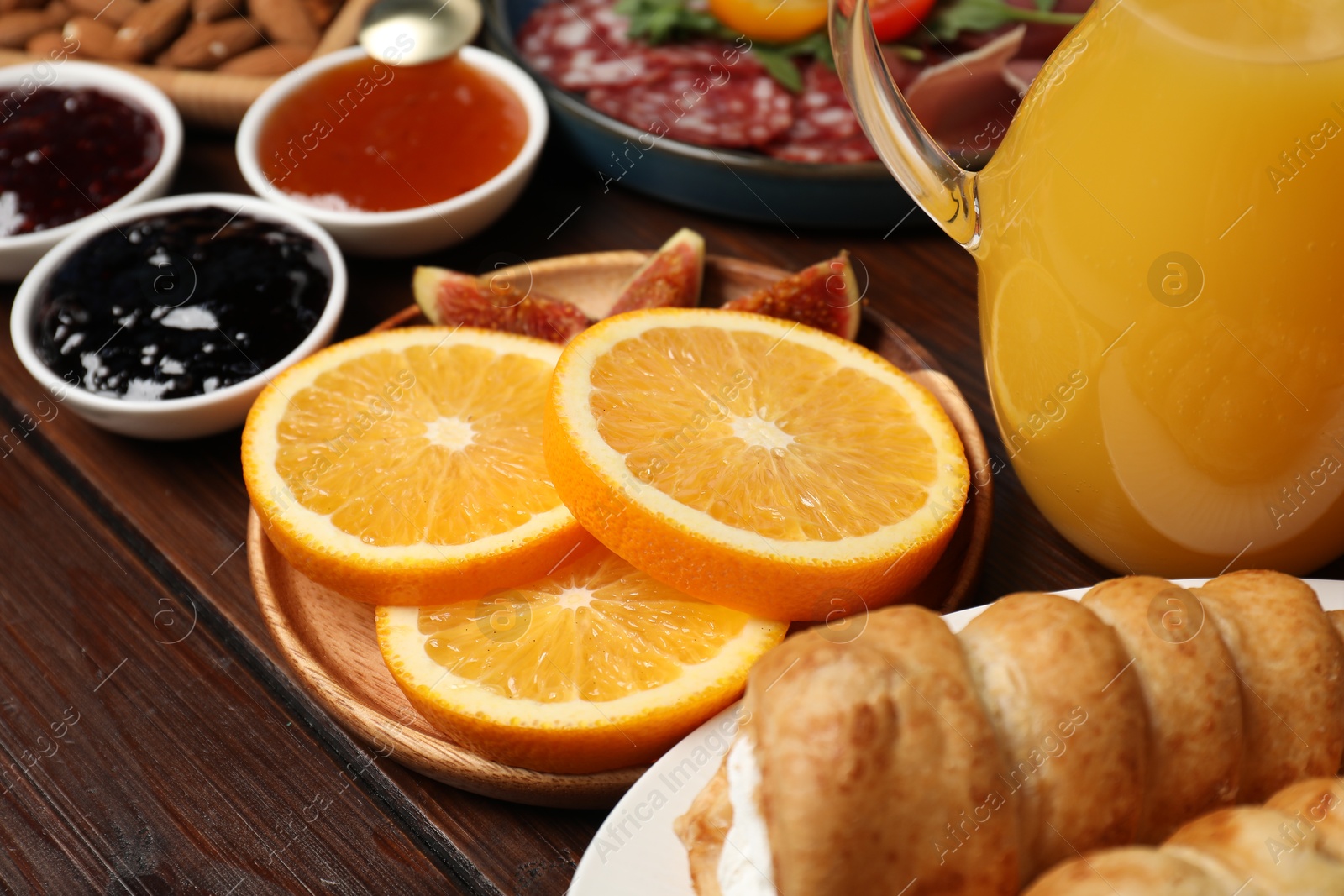 Photo of Different tasty food served for brunch on wooden table, closeup