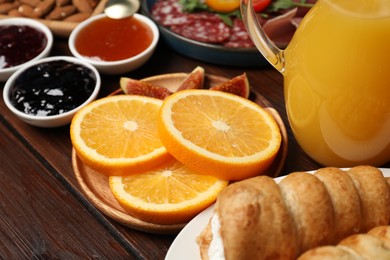 Photo of Different tasty food served for brunch on wooden table, closeup