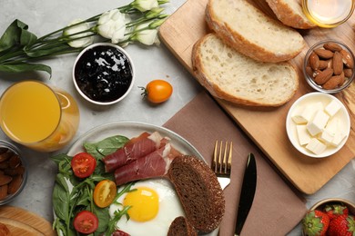 Photo of Different tasty food served for brunch on grey marble table, flat lay