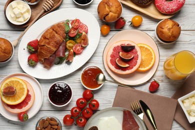 Photo of Different tasty food served for brunch on white wooden table, flat lay