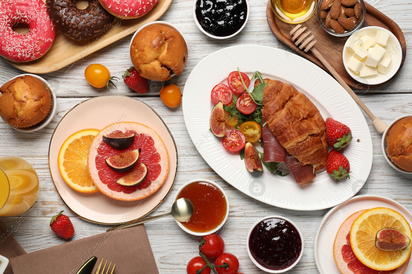 Photo of Different tasty food served for brunch on white wooden table, flat lay