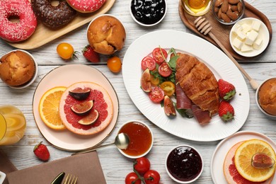 Photo of Different tasty food served for brunch on white wooden table, flat lay