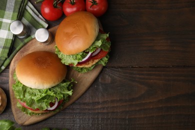 Photo of Delicious vegetarian burgers with chickpea cutlets on wooden table, flat lay. Space for text