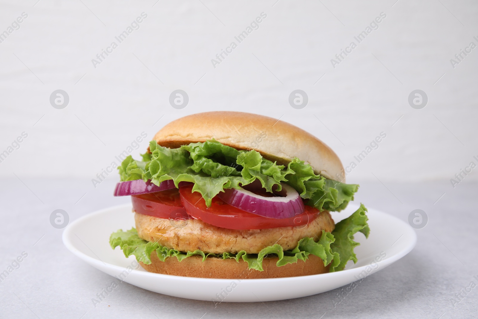 Photo of Delicious vegetarian burger with chickpea cutlet on light table, closeup